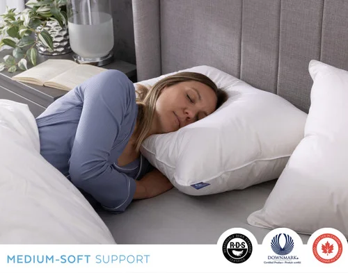 Woman resting on her side on our Luxurious Down Pillow.