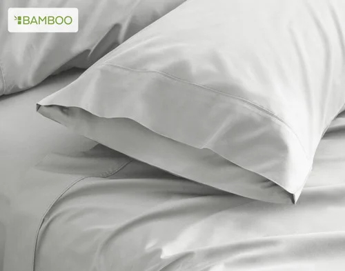 Our Bamboo Cotton Pillowcases with Activated Charcoal resting on a bed.