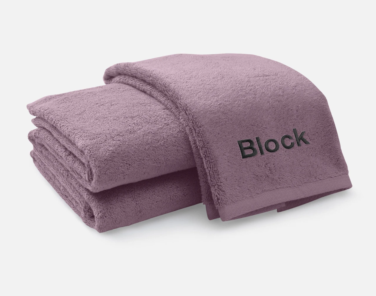 Folded view of our Custom Embroidered Towel Set in Lilac Ash, featuring Block font embroidered in white black along its bottom edge.