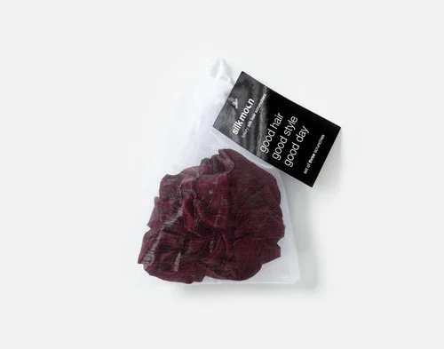 Top view of the mesh bag packaging holding our Purple Mulberry Silk Scrunchie Set.