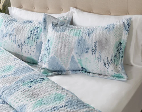 Angled view of a pillow sham of our Eliana Coverlet Set.