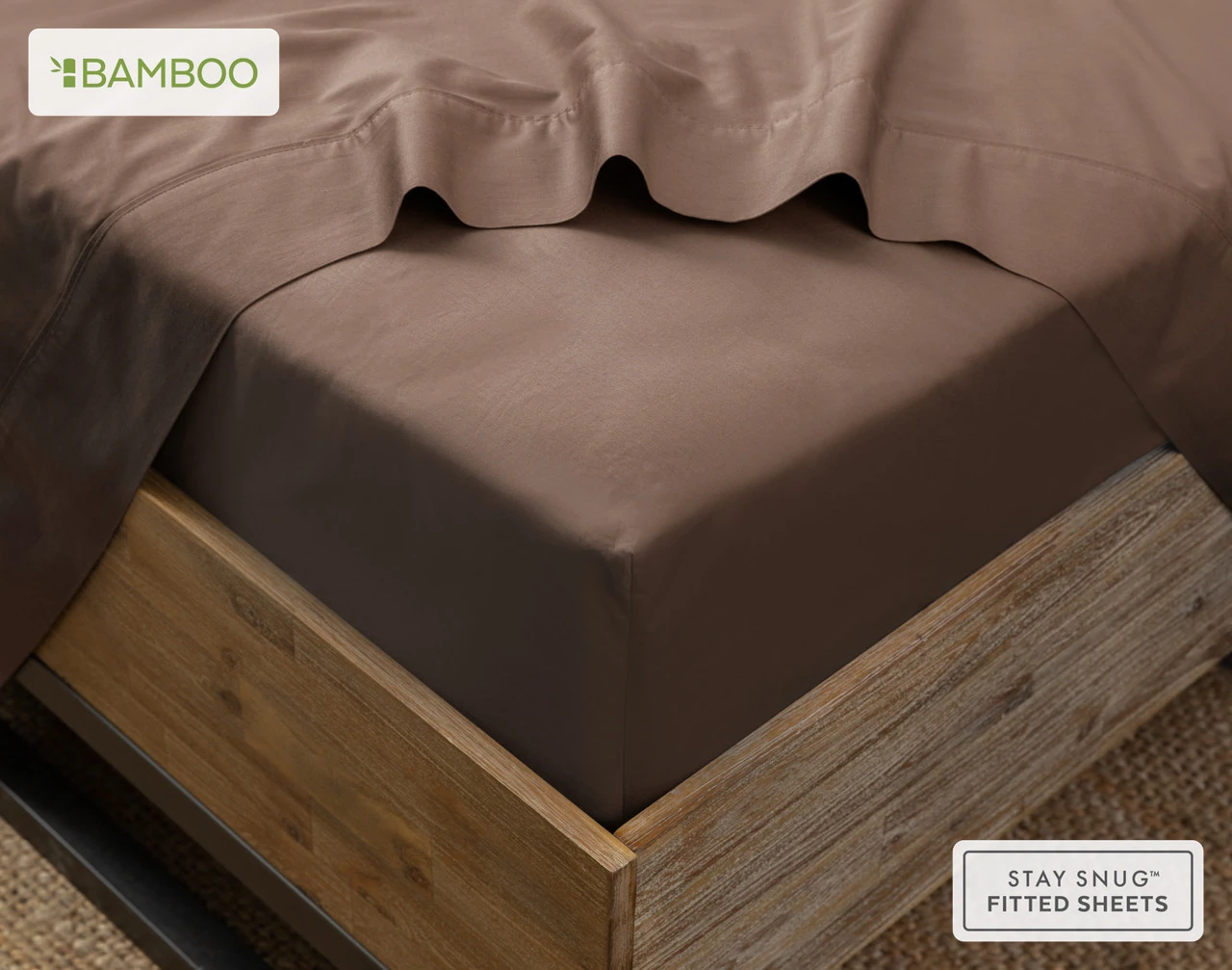 Our Bamboo Cotton Fitted Sheet in Mocha Whip on the corner of a bed with its matching flat sheet.