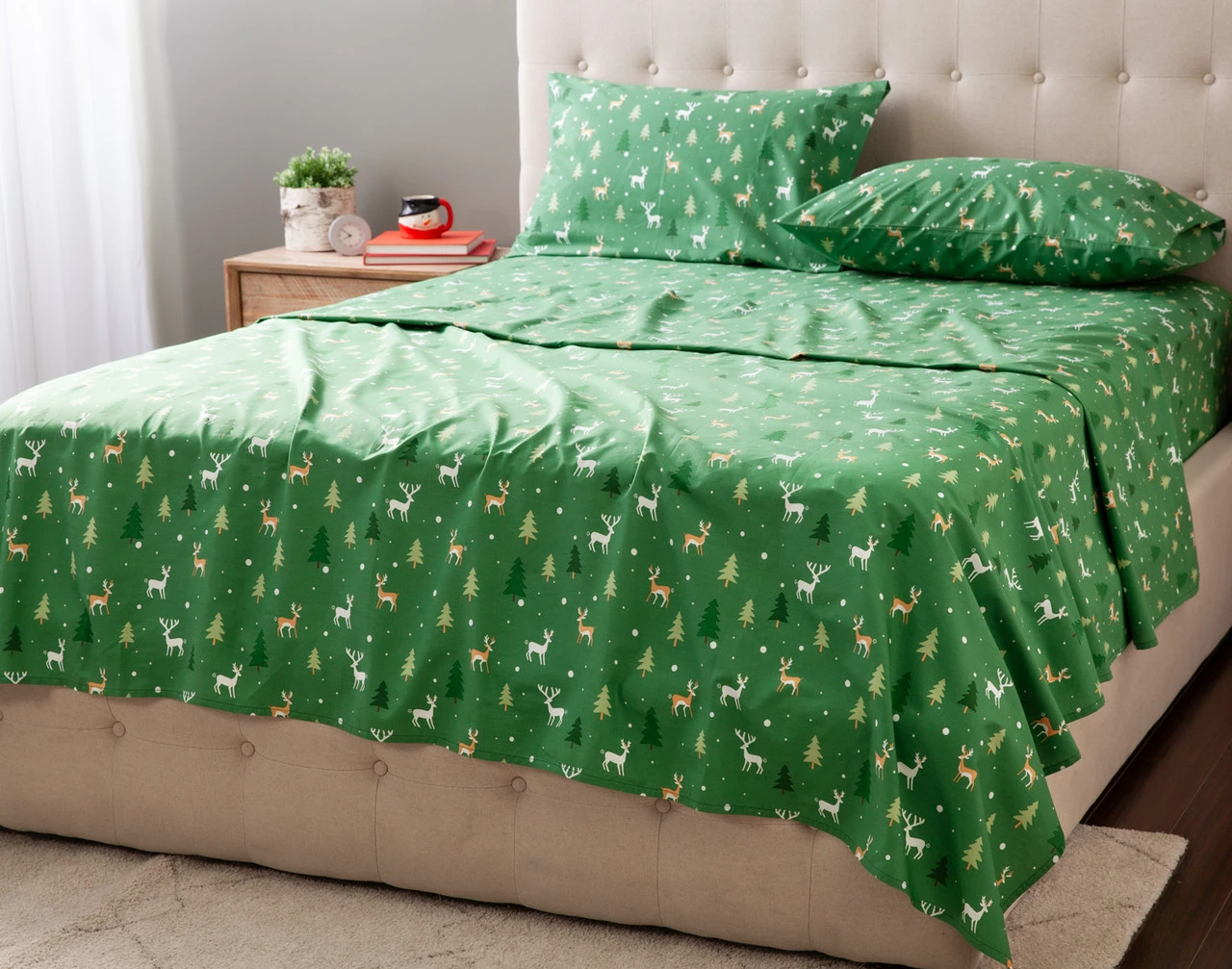 Angled view of our Reindeer Ridge Holiday Sheet Set dressed over a queen bed.