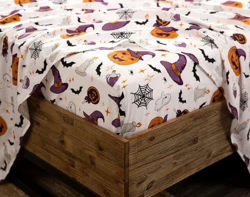 Close-up on the fitted sheet from Hallows Eve Cotton Percale Sheet Set on the corner of a mattress.