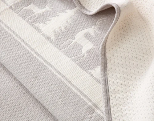 Close up on the folded surface of our Deer Trail Cotton Quilt Set to show the main and reverse surfaces.