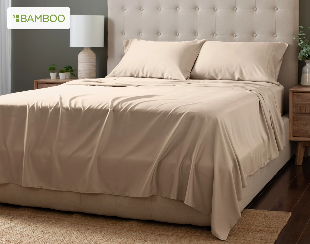Angled view of our Tan Bamboo Moon Sheet Set dressed over a plain queen bed.