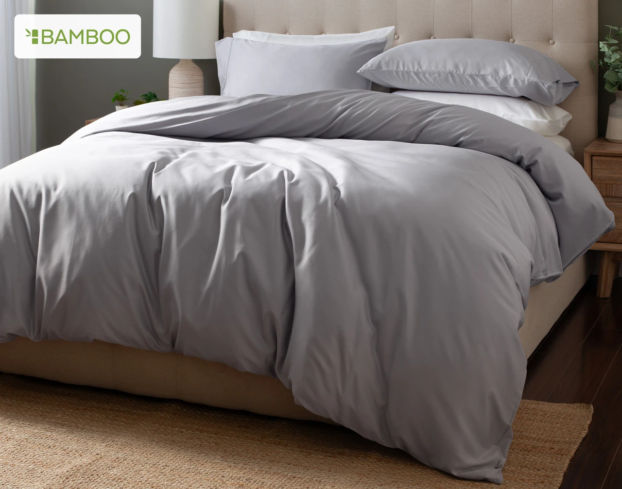 Angled view of our Flint Grey Bamboo Moon Duvet Cover Set dressed over a plain bed.