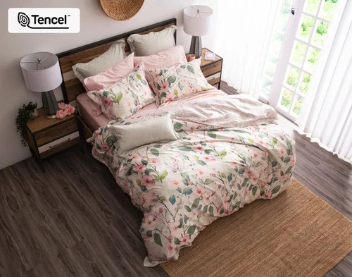 Top-down shot of our Enamour Duvet Cover with pink accessories.