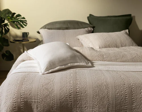 Front, off-centre view of our Rustico collections dressing a bed with green sheeting.