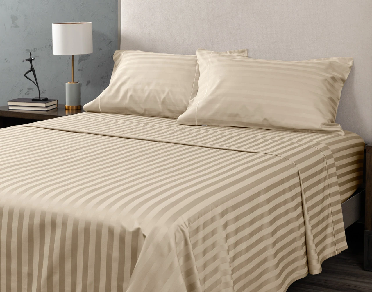 Angled view of our Almond Luxor Egyptian Cotton Sheet Set dressed over a plain queen bed.