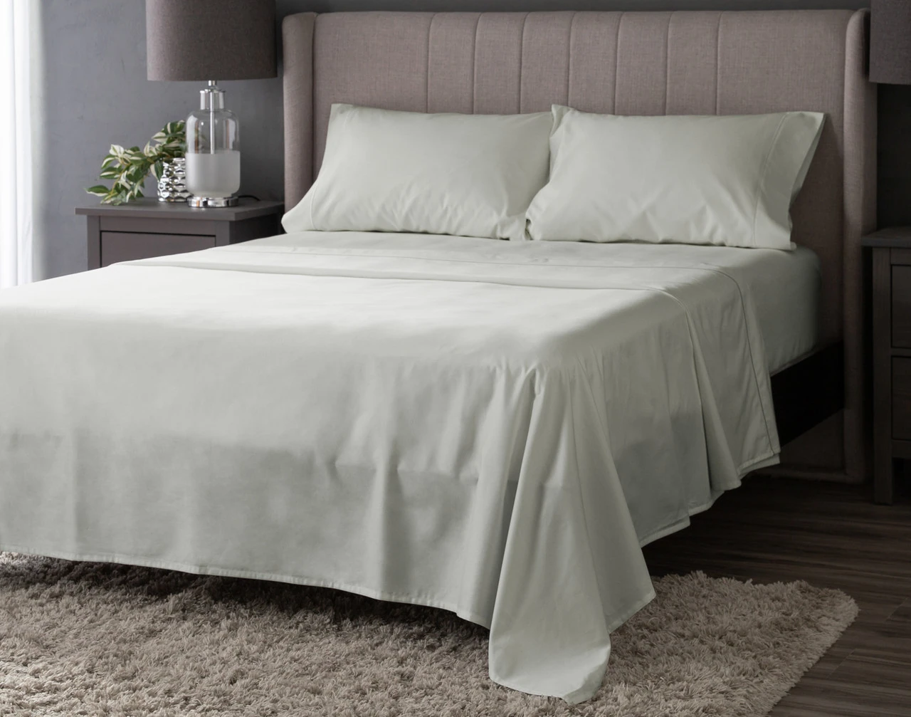 Angled view of our Seabreeze Luxor Egyptian Cotton Sheet Set dressed over a plain queen bed.