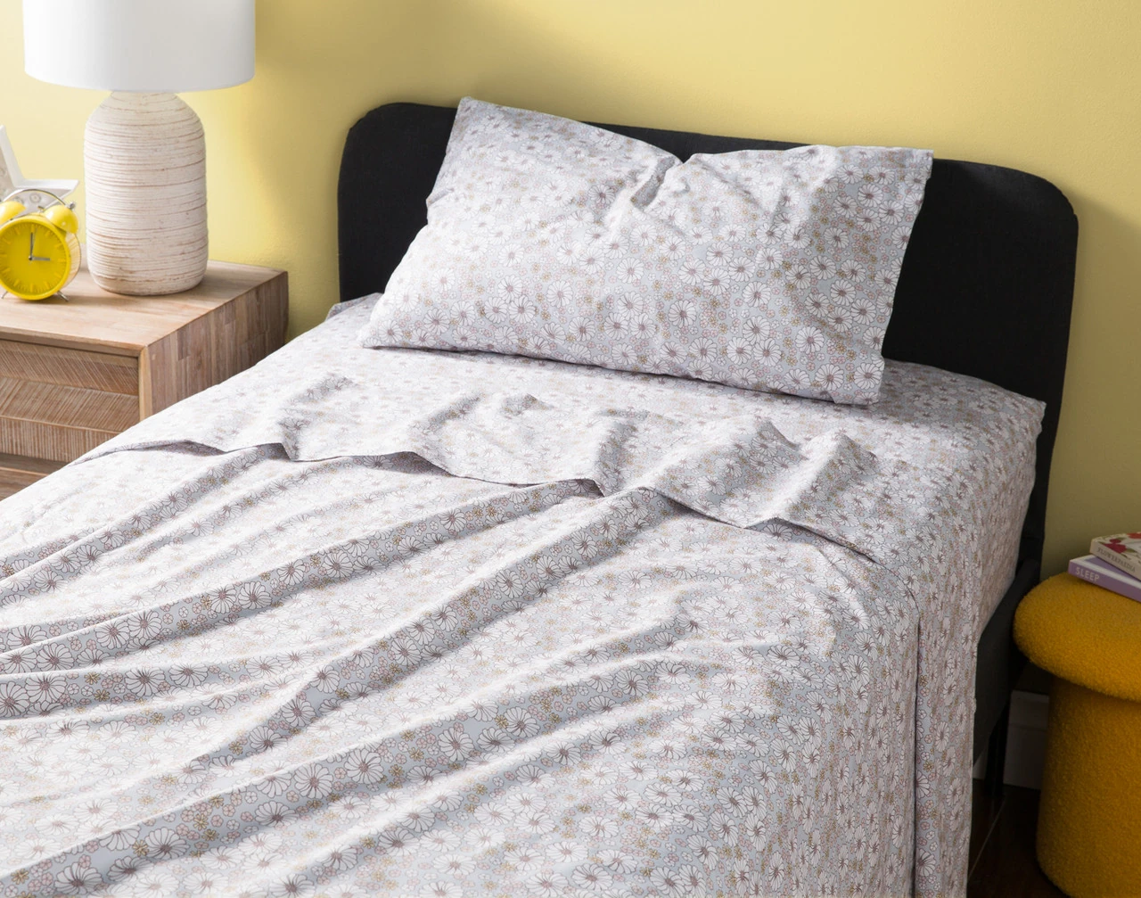 Angled view of our Flora Kids' Cotton Sheet Set dressed over a twin bed.