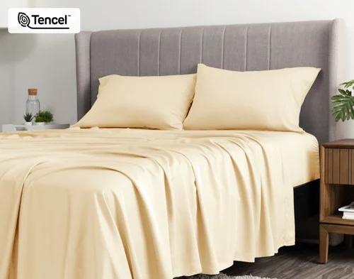 Angled view of a queen bed dressed in our BeechBliss TENCEL™ Modal Sheet Set in Cornsilk.