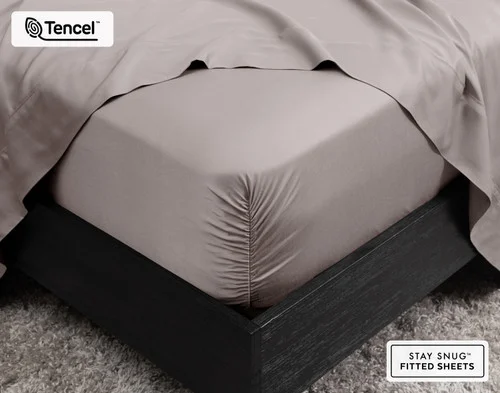 Close-up on the corner of our BeechBliss TENCEL™ Modal Fitted Sheet in Beachcomber fit over a queen mattress.