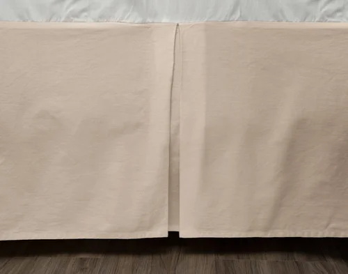 Close-up of our Cotton Twill Bedskirt in Ranchwood draped along the side of a bed frame.