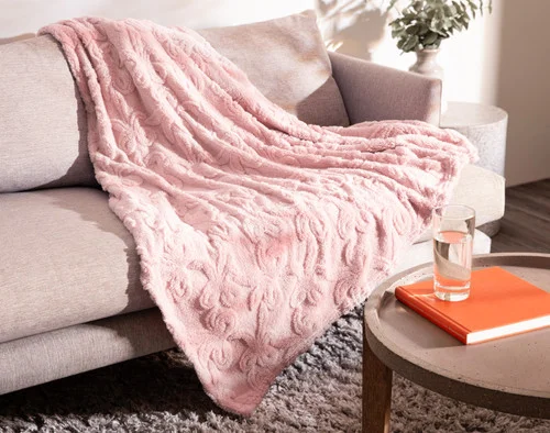 Our Valentine's Fleece Throw - Etched Bows draped over a grey couch.