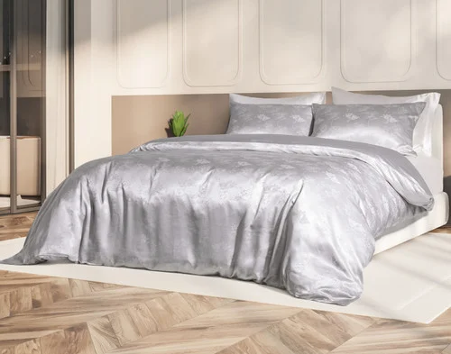 Our Reflections Silk Blend Duvet Cover Set dressed over a large bed in a sunlit bedroom.