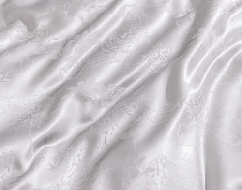 Close-up of the etched floral surface design on our Reflections Silk Blend Duvet Cover Set.