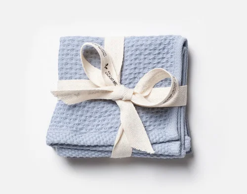 Our Dusty Blue Cotton Knit Dishcloths folded and wrapped in a white bow.