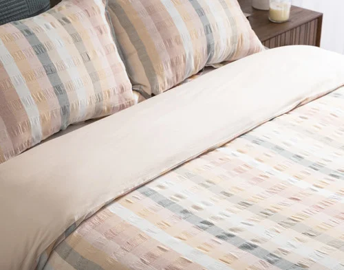 Closer, angled view of our Carmen Duvet Cover and Pillow Shams on a bed.