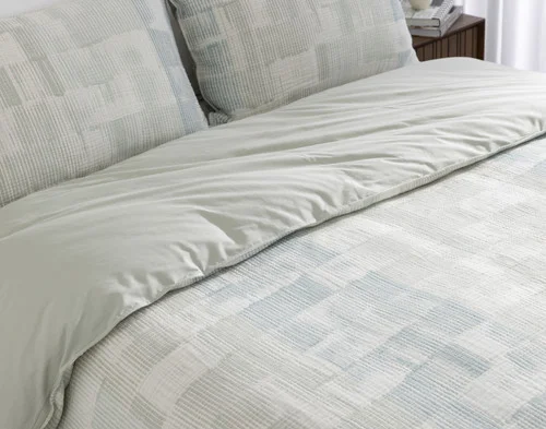 Folded edge of our Palette Duvet Cover to show its patterned surface and solid reverse.