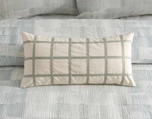 Our Palette Boudoir Pillow Cover resting on a bed with its coordinating duvet cover.