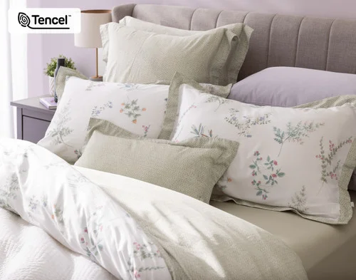 Angled view of our Annika collection dressing the head of a bed with accessories.