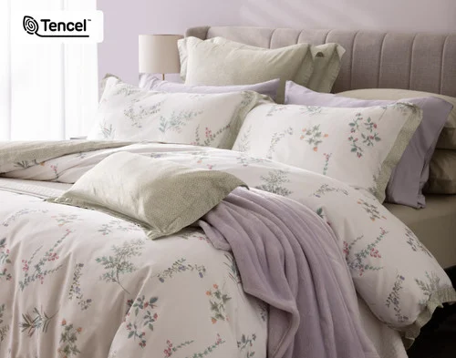 Angled view of our Annika collection dressing the head of a bed with accessories.