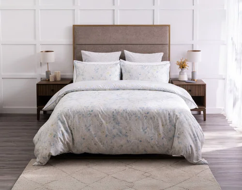 Front view of our Josephine Duvet Cover dressing a queen bed in a modern white room.