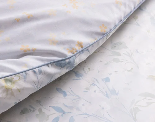 Close up on the folded surface of our Josephine Duvet Cover to show the main and reverse sides.