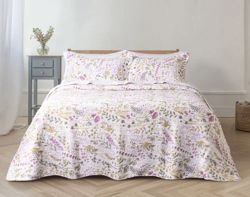 Front view of our Zoey Cotton Quilt Set dressed over an empty queen bed.