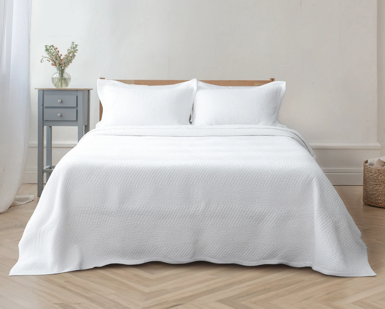 Front view of our White Hermosa Quilt Set dressed over a plain queen bed.