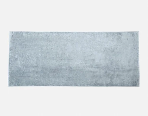 Our Blue Dusk Modal Cotton Bath Sheet sitting flat on a white backdrop.