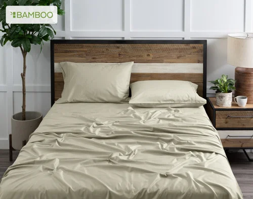 Front view of our Bamboo Cotton Sheet Set in Thyme dressing a bed in a simple bedroom.