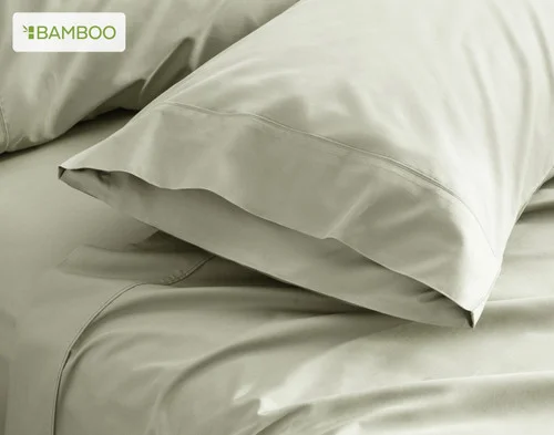 Our Bamboo Cotton Pillowcases in Thyme resting on a bed.