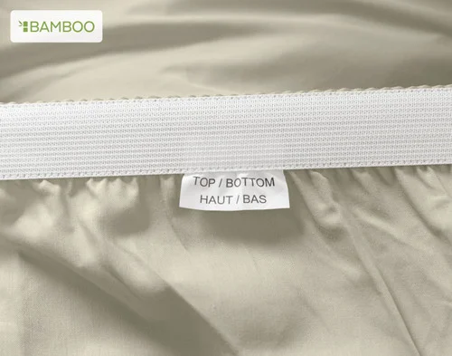 The Top/Bottom tag on our Bamboo Cotton Fitted Sheet in Thyme.