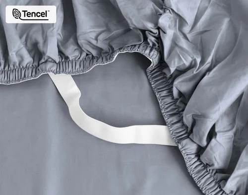 Close-up on the elastic snug fit band on the corner of our Eucalyptus Luxe TENCEL™ Lyocell Fitted Sheet in Cliffside.
