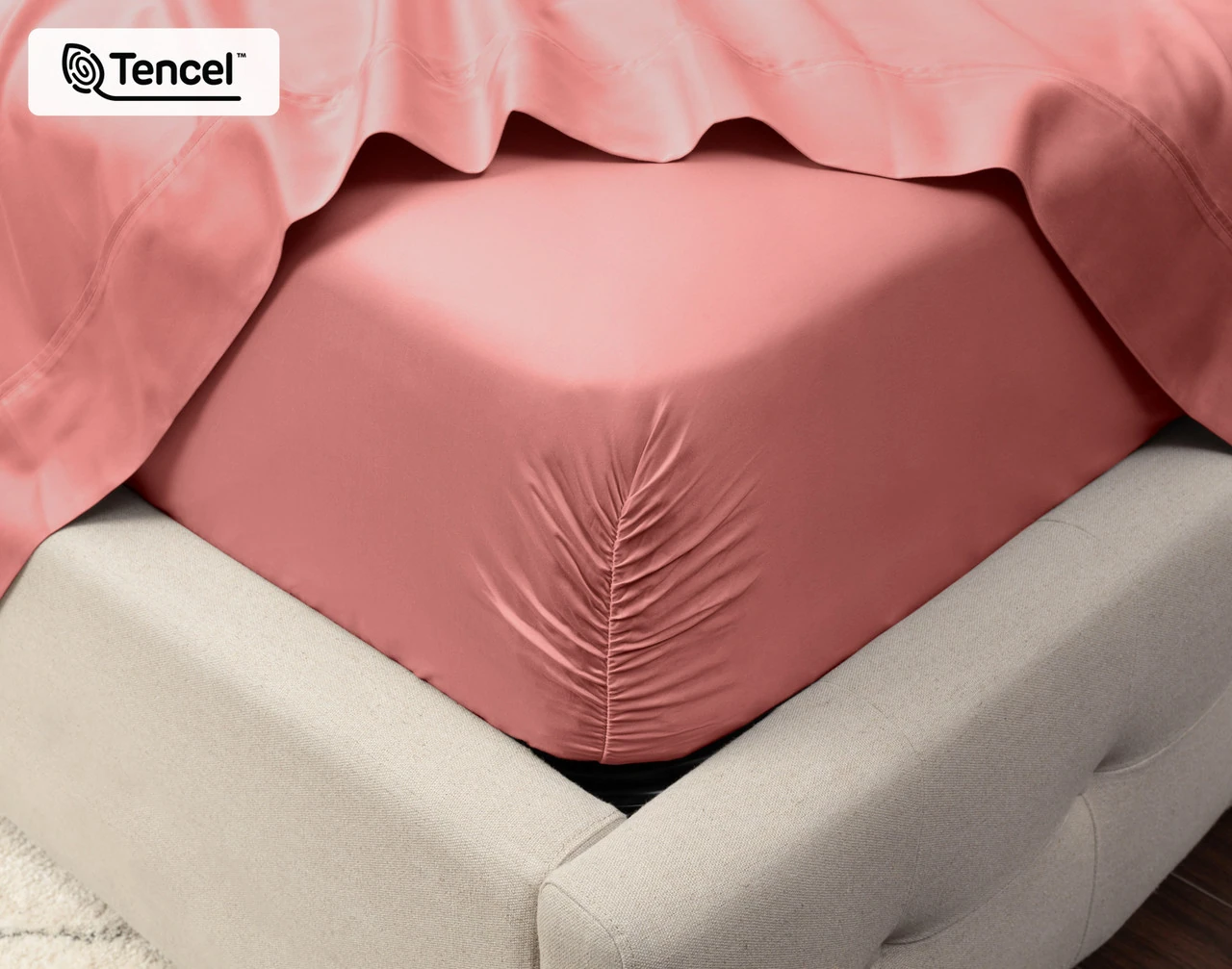 Close-up on the corner of a mattress with our Eucalyptus Luxe TENCEL™ Lyocell Fitted Sheet in Raspberry Ice to show its snug fit.