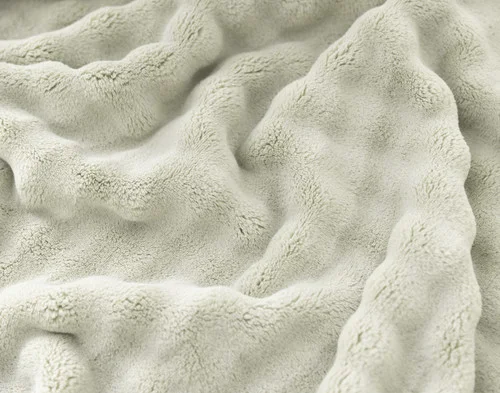 Close-up of the bubbled texture on our Sage Bubble Breeze Throw.