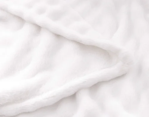 Folded edge of our White Bubble Breeze Throw to show its surface and reverse.