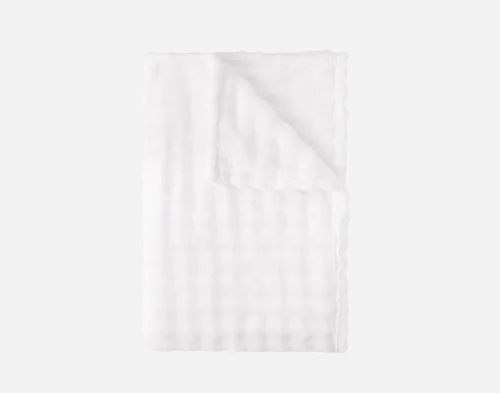 Our White Bubble Breeze Throw folded into a rectangle.