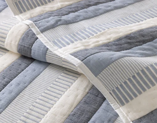 Close up on our folded Piers Cotton Quilt Set to show the texture.
