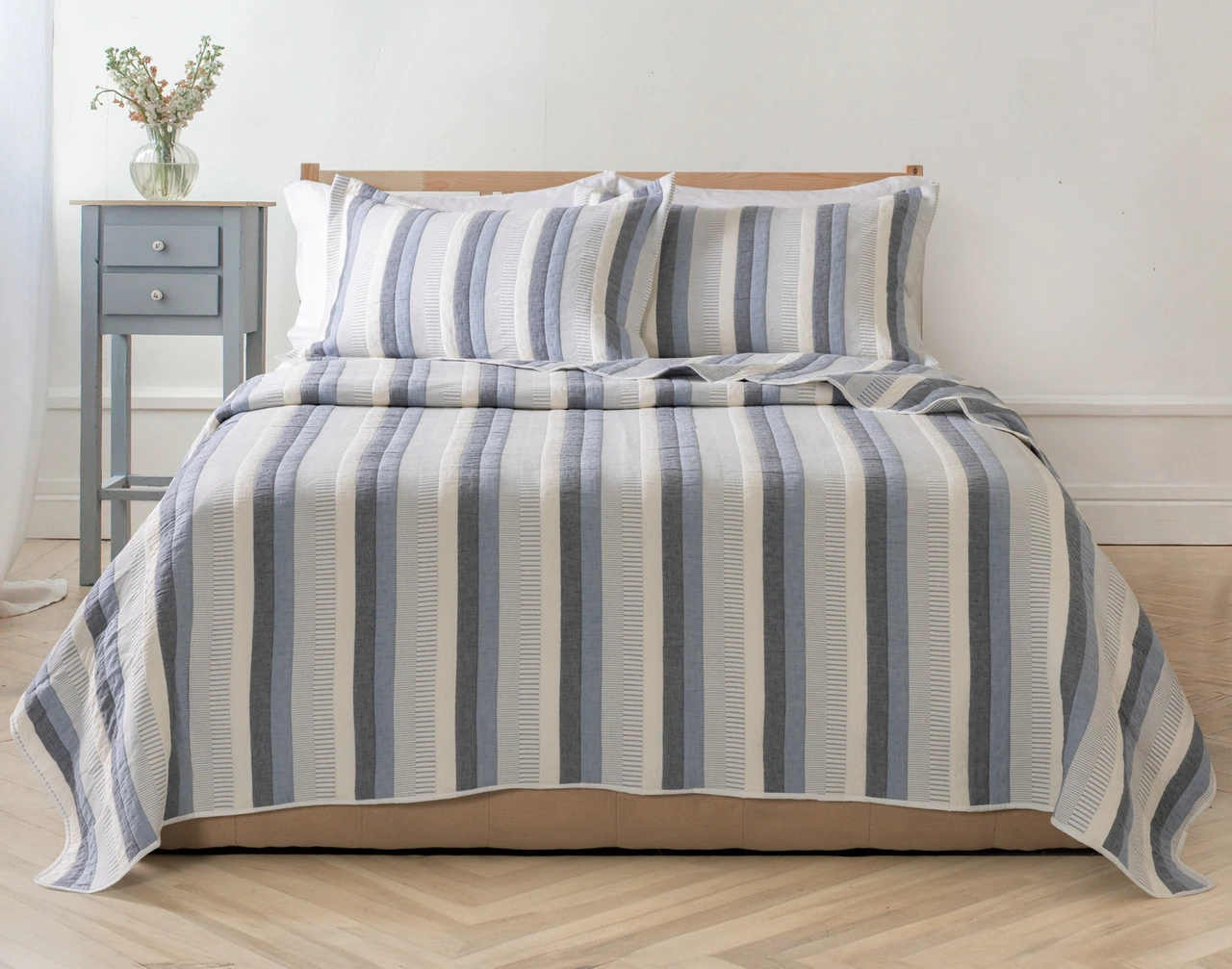 Our Piers Cotton Quilt Set decorating a queen bed in a simple bedroom.