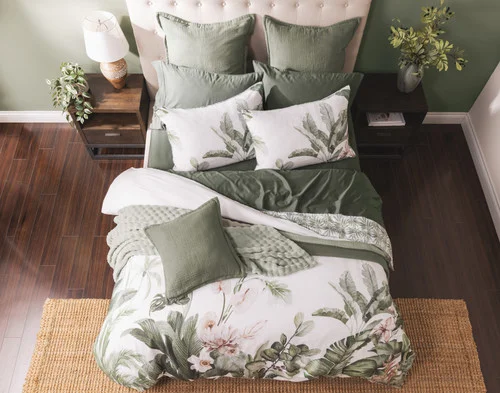 Top-down view of our Sail Away Duvet Cover with green accessories.