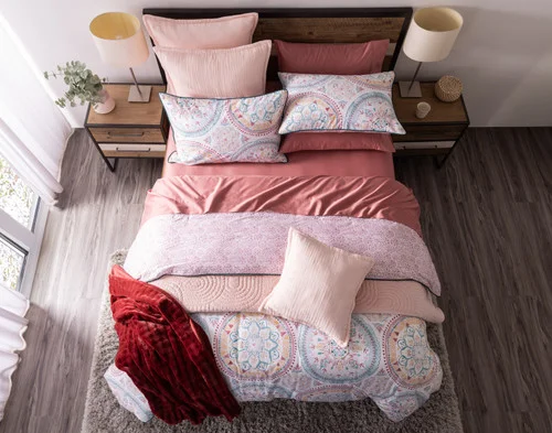 Straight view of our Mandira Duvet Cover Set dressing a queen bed with blue accessories.