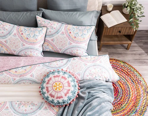 Top-down view of our Mandira Duvet Cover Set dressing a queen bed with blue accessories.