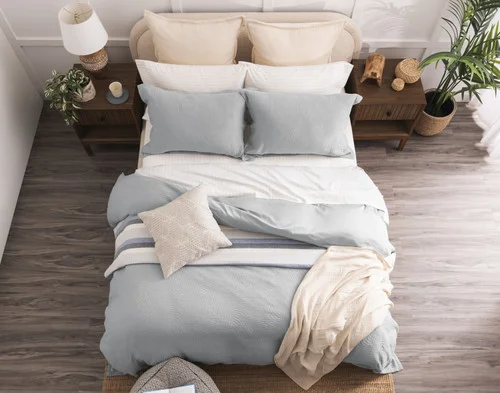 Top-down view of our Cielo Duvet Cover Set dressing a queen bed with orange accessories.