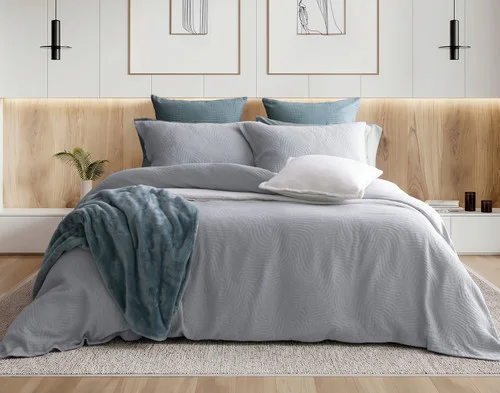 Front view of our Cielo Duvet Cover Set dressing a queen bed with green accessories.