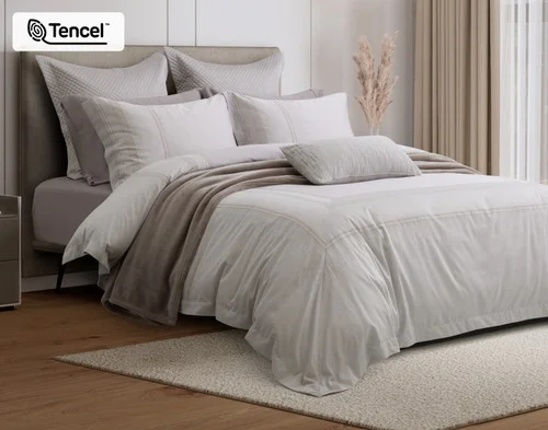 Angled view of our Renley Duvet Cover dressing a queen bed with accessories.