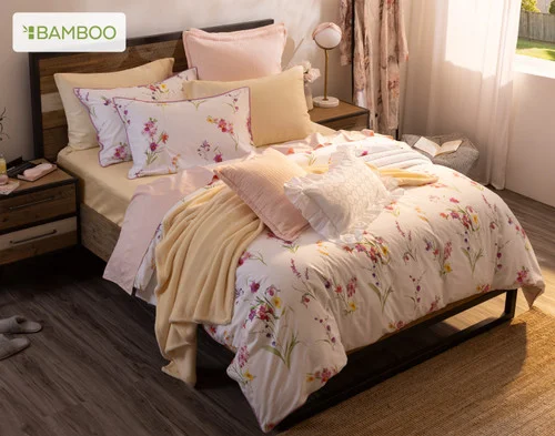 Angled, top-down view of our Delicata collection dressing a queen bed with yellow accessories.